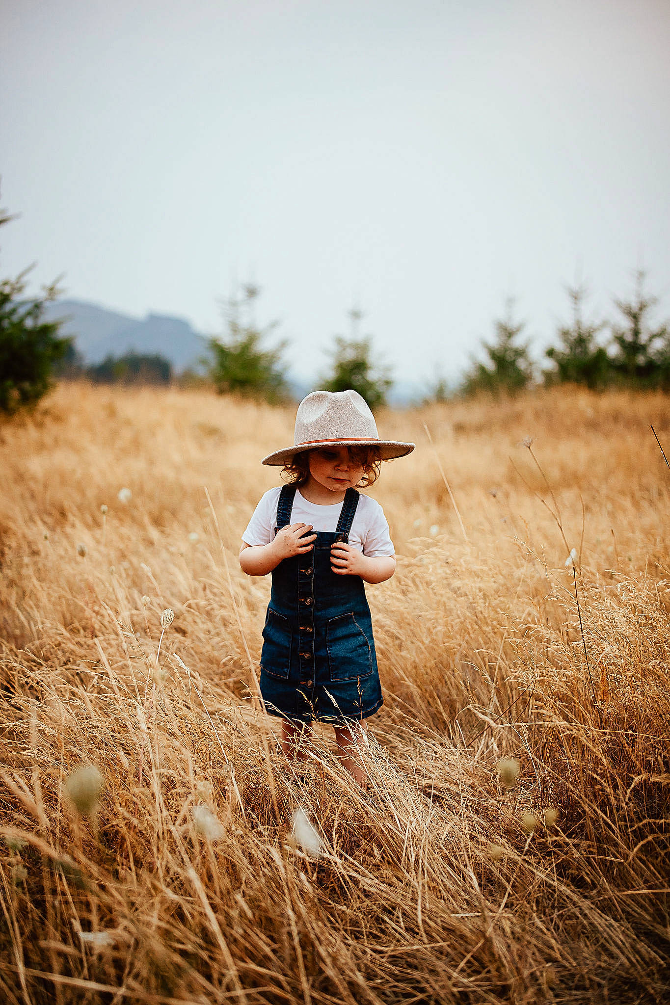 Holley is registered to the contest to win money with this photo: agriculture, ecoregion, flash_photography, grass, grass_family, grassland, happy, hat, headgear, headwear, horizon, landscape, meadow, natural_landscape, people_in_nature, person, plain, plant, prairie, sky