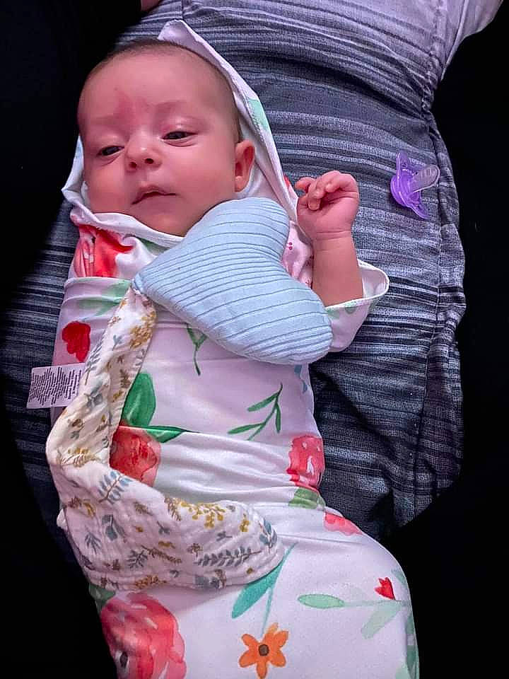 Arya is registered to the contest to win money with this photo: baby, baby_carriage, baby_products, baby_toddler_clothing, bib, cheek, child, comfort, gesture, grass, hand, happy, head, human_body, lip, person, pink, skin, sleeve, toddler