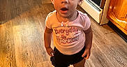 Aylarae is registered to the contest to win money with this photo: blackboard, brownhair, clothing, face, footwear, hair, hardwood, head, indoors, interiordesign, person, photography, portrait, shoe, shorts, sitting, sleeve, stainedwood, standing, wood