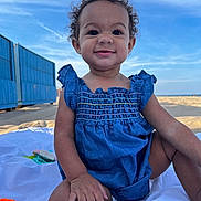 Aylarae joined the competition — help win amazing prizes! architecture, baby, beach, building, clothing, coast, face, happy, head, jeans, outdoors, pants, person, photography, portrait, shelter, shorts, sitting, smile, summer