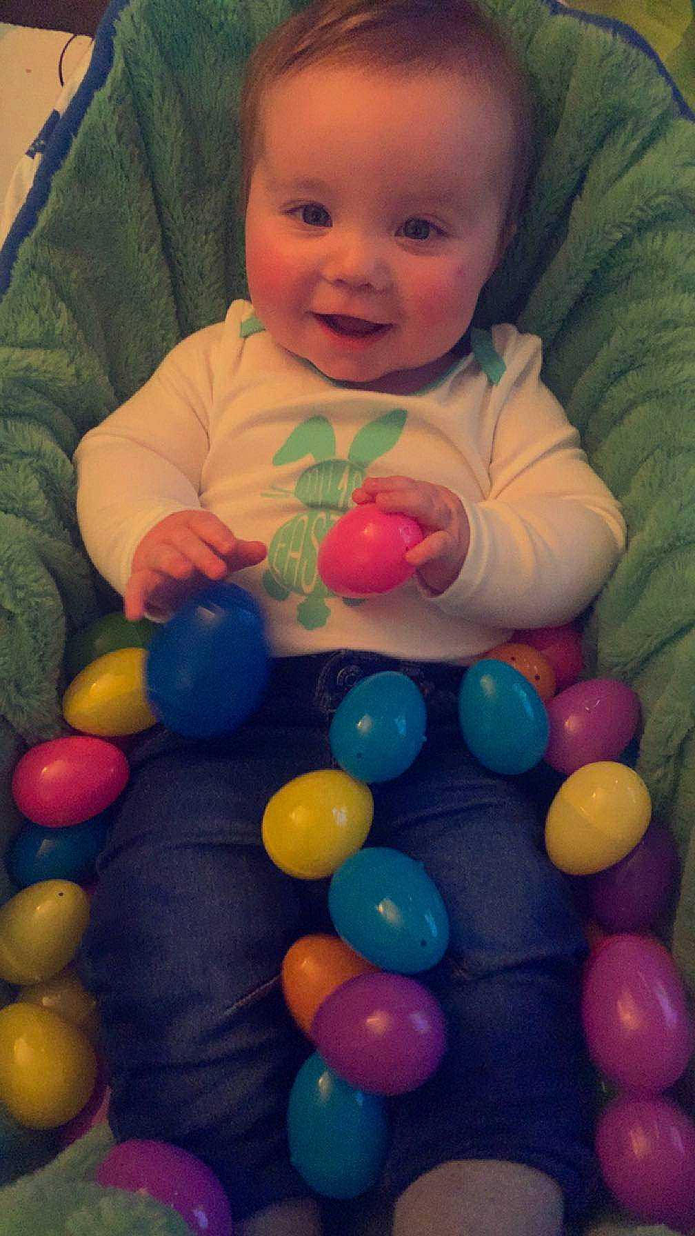 Ashton is registered to the contest to win money with this photo: baby, baby_toddler_clothing, ball_pit, balloon, beauty, cheek, child, eye, fun, green, hand, happy, head, human_body, iris, organ, person, photograph, smile, snapshot