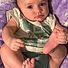 Kyrsten is registered to the contest to win money with this photo: baby, blanket, child, clothing, comfort, cute, diaper, expression, face, feet, hands, indoors, infant, lying_down, portrait, purple, skin, soft_texture, toddler, young