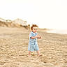 Colton is registered to the contest to win money with this photo: toddler, child, beach, sand, barefoot, curly_hair, blue_clothing, sunset, walking, outdoor, smiling, ocean, coast, summer, nature, shore, casual_wear, young_child, happy, daylight