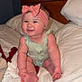 Christina is registered to the contest to win money with this photo: baby, infant, child, smile, headband, onesie, bed, pillow, blanket, toes, feet, hand, arm, cheeks, cute, chubby, indoors, wood_headboard, portrait, happy