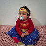 Kylie joined the competition — help win amazing prizes! toddler, child, wonder_woman_costume, pacifier, blue_tutu, gold_stars, pink_blanket, gold_shoes, headband, curly_hair, indoor, cute, costume, sitting, young_child, wall, portrait, red_shirt, gold_belt, small_footwear