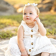 Brinsley joined the competition — help win amazing prizes! baby, child, white_dress, bow, outdoor, sunlight, blanket, sitting, cute, portrait, infant, young_child, nature, grass, face, blue_eyes, happy, soft_light, summer, youth