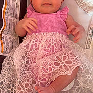 Summer is registered to the contest to win money with this photo: baby, infant, pink_clothing, headband, lace, dress, cute, child, portrait, laying_down, hands, feet, fabric, soft_texture, cushion, indoor, looking_at_camera, adorable, young_child, smiling