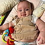 baby, infant, diaper, toy, bottle, cushion, clothing, face, person, arm, hand, smile, indoor, corduroy, plastic, milk, comfortable, cute, relaxed, star_pattern