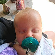 Timothy joined the competition — help win amazing prizes! baby, pacifier, sleeping, blanket, infant, child, closeup, indoor, person, can, energy_drink, table, figurine, decor, soft_light, purple_clothing, peaceful, resting, toddler, napping