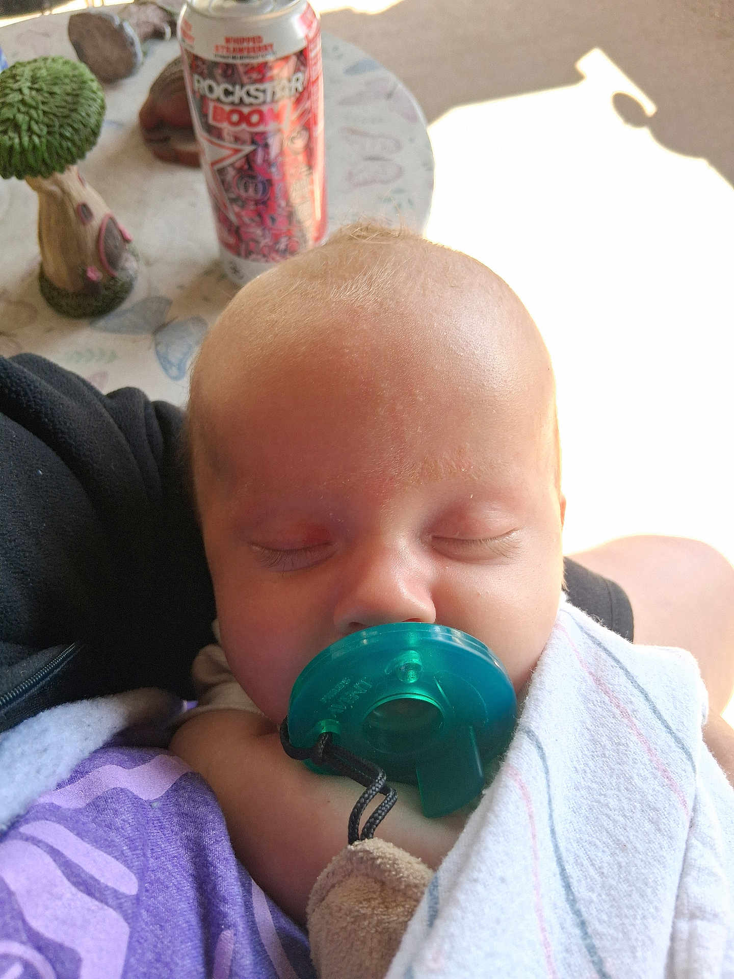 Timothy joined the competition — help win amazing prizes! baby, pacifier, sleeping, blanket, infant, child, closeup, indoor, person, can, energy_drink, table, figurine, decor, soft_light, purple_clothing, peaceful, resting, toddler, napping