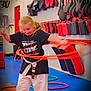 acrobatic, athlete, bodypart, boy, child, clothing, face, finger, hand, head, indoors, karate, lifejacket, male, martialarts, pants, person, sport, t_shirt, vest