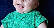 Brody Wayne joined the competition — help win amazing prizes! baby, child, smiling, blue_eyes, green_shirt, dinosaur_pattern, happy, portrait, infant, cute, lying_down, toddler, short_hair, skin, face, one_person, indoors, bright, closeup, cheerful