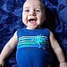 Brody Wayne is registered to the contest to win money with this photo: baby, child, smiling, blue_tank_top, octopus_design, blanket, happy, cute, infant, portrait, face, blue_eyes, clothing, casual, lying_down, soft_texture, playful, young_child, cheerful, skin
