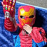 blue_blanket, carpet, child, colorful, costume, eye, face, fingers, hand, indoor, infinity_gauntlet, iron_man, mask, play, pose, red, spiderman, superhero, toy, yellow