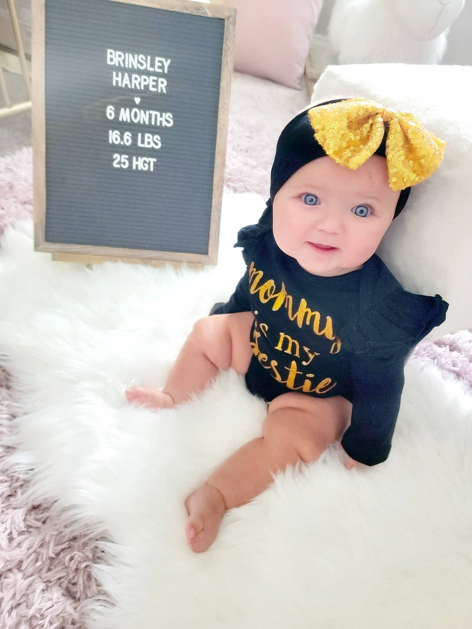 Brinsley is registered to the contest to win money with this photo: baby, baby_toddler_clothing, beanie, cap, child, costume_hat, fashion_accessory, finger, font, hair_accessory, happy, headband, headgear, headwear, person, room, sitting, skin, sleeve, t_shirt
