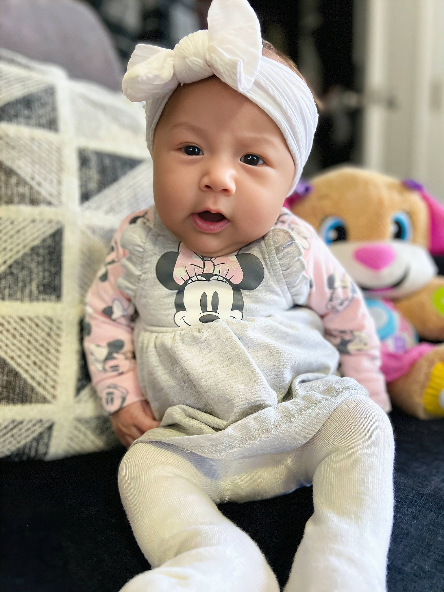 Athena is registered to the contest to win money with this photo: baby, baby_toddler_clothing, cap, cheek, child, comfort, fashion_accessory, fur, happy, headwear, pattern, person, pink, portrait_photography, sitting, skin, sleeve, stuffed_toy, textile, toddler
