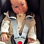 baby, infant, car_seat, safety_harness, pajamas, blue_eyes, face, hands, clothing, seat, child, cute, indoor, newborn, portrait, infant_clothing, straps, button, soft_light, serious_expression