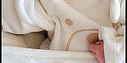 Ella participe au concours pour gagner de l'argent avec cette photo : adorable, baby, baby_bedding, bed, blanket, child, closeup, cute, duck_pattern, indoors, infant, newborn, newborn_outfit, peaceful, pillow, resting, sleeping, smiling, soft_texture, white_clothing