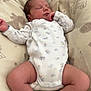 newborn, baby, sleeping, onesie, infant, cushion, baby_seat, animal_print, blanket, cozy, peaceful, indoors, soft_lighting, cute, resting, child, human, legs, hand, face
