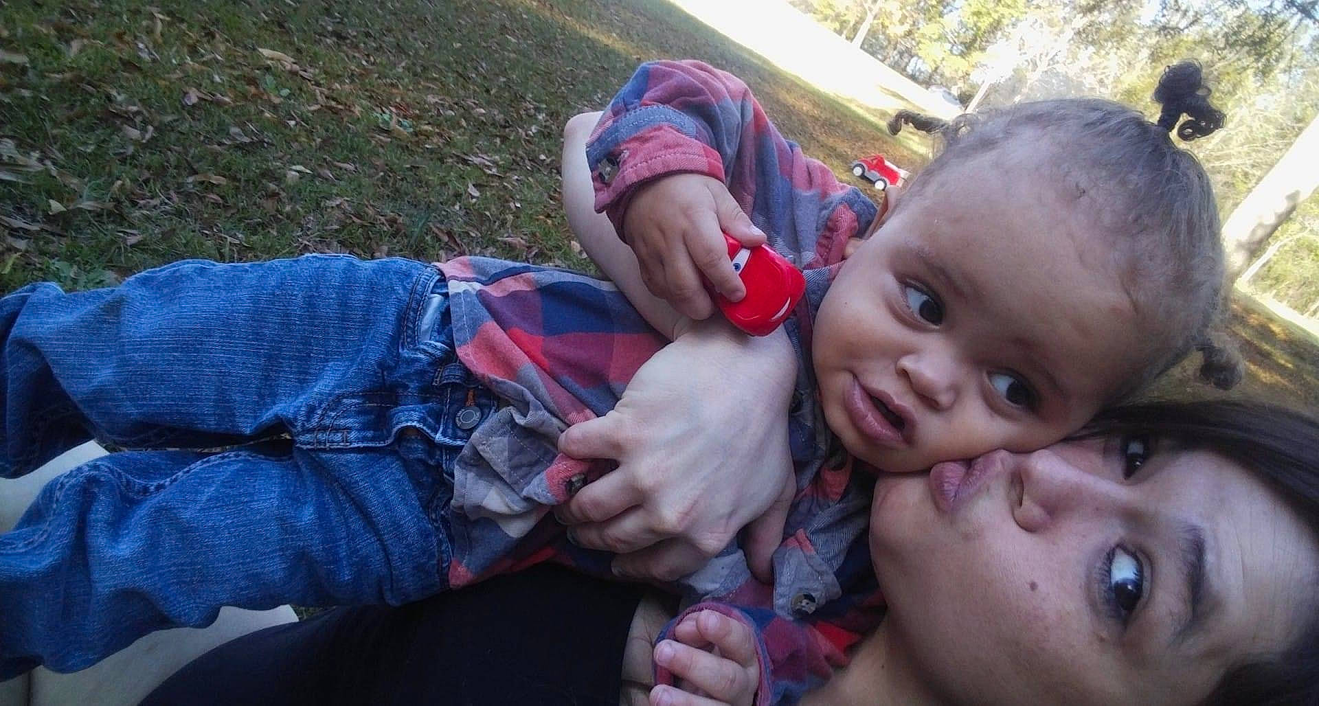 Dallas joined the competition — help win amazing prizes! baby, child, denim, event, finger, fun, gesture, grass, hand, happy, leaf, leisure, nail, person, plant, sitting, thumb, toddler, tree, vacation