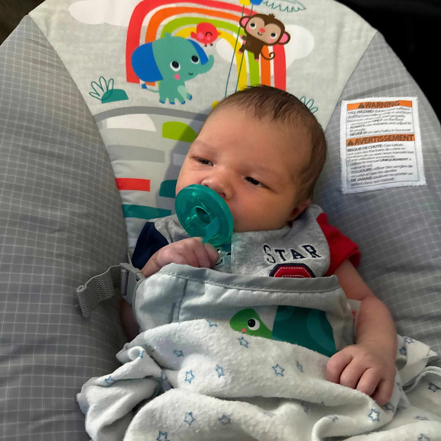 Atticus joined the competition — help win amazing prizes! baby, baby_seat, blanket, child, clothing, comfort, cute, elephant, face, hand, indoors, infant, monkey, pacifier, pattern, rainbow, resting, soft, sun, young