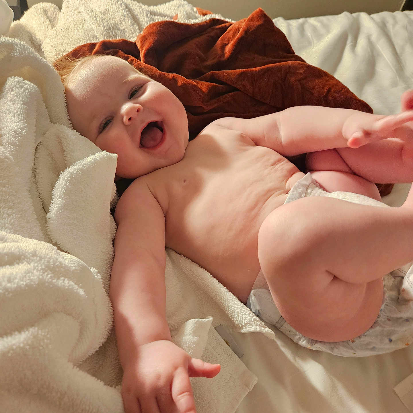 Charlotte is registered to the contest to win money with this photo: arm, baby, bed, blanket, child, cozy, cute, diaper, expression, foot, hand, happy, indoors, infant, leg, person, playful, skin, smiling, soft