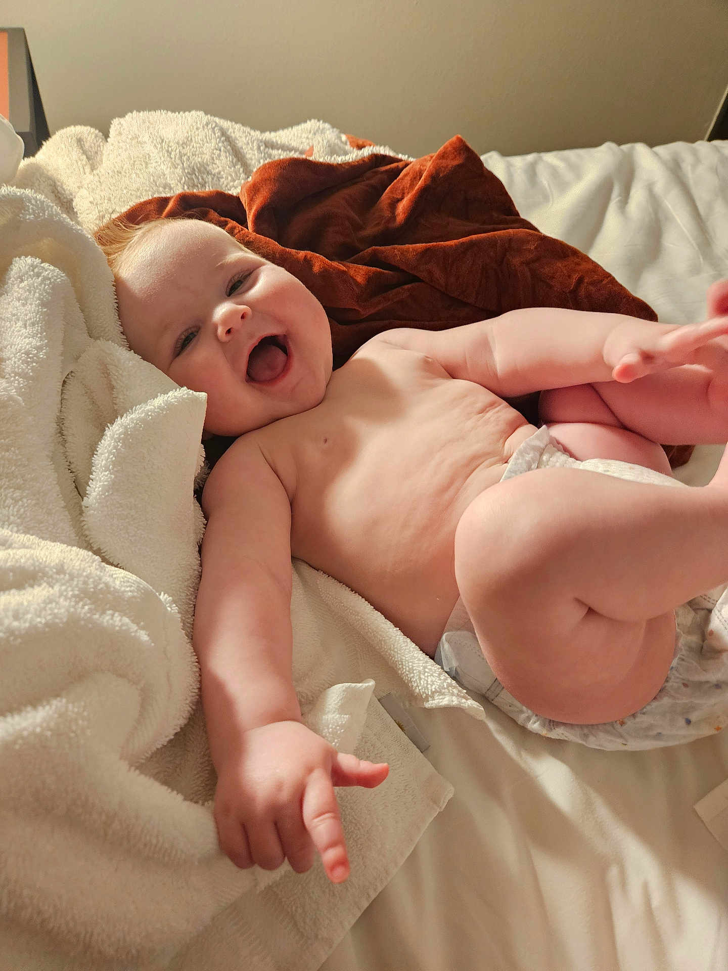 Charlotte is registered to the contest to win money with this photo: baby, infant, smiling, happy, bed, blanket, diaper, skin, arm, leg, hand, foot, indoors, soft, cozy, child, person, expression, cute, playful