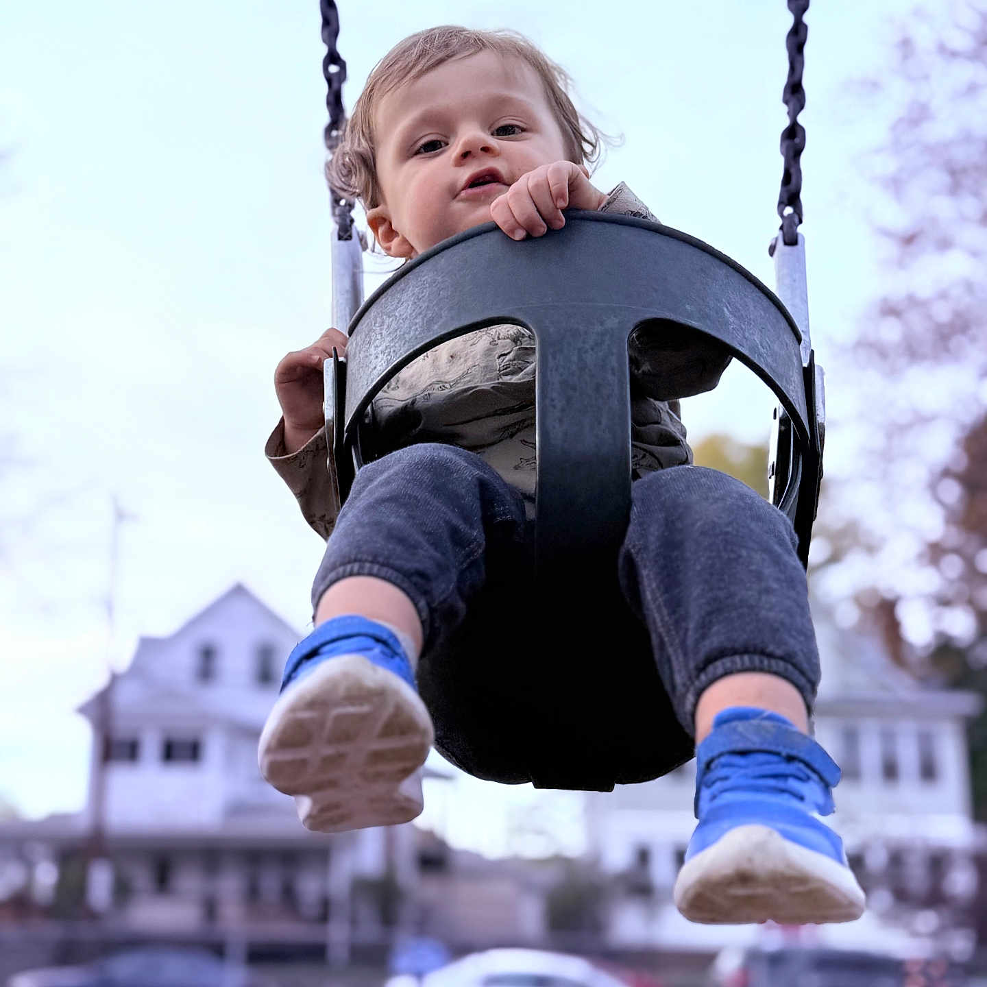 Liam is registered to the contest to win money with this photo: baby, car, clothing, face, footwear, head, helmet, outdoorplayarea, outdoors, pants, person, photography, playarea, portrait, shoe, sneaker, swing, toy, transportation, vehicle