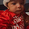 baby, child, infant, santa_hat, red_clothing, holiday, festive, portrait, cute, face, indoors, soft_lighting, person, christmas, seasonal, cozy, expression, young_child, smile, celebration