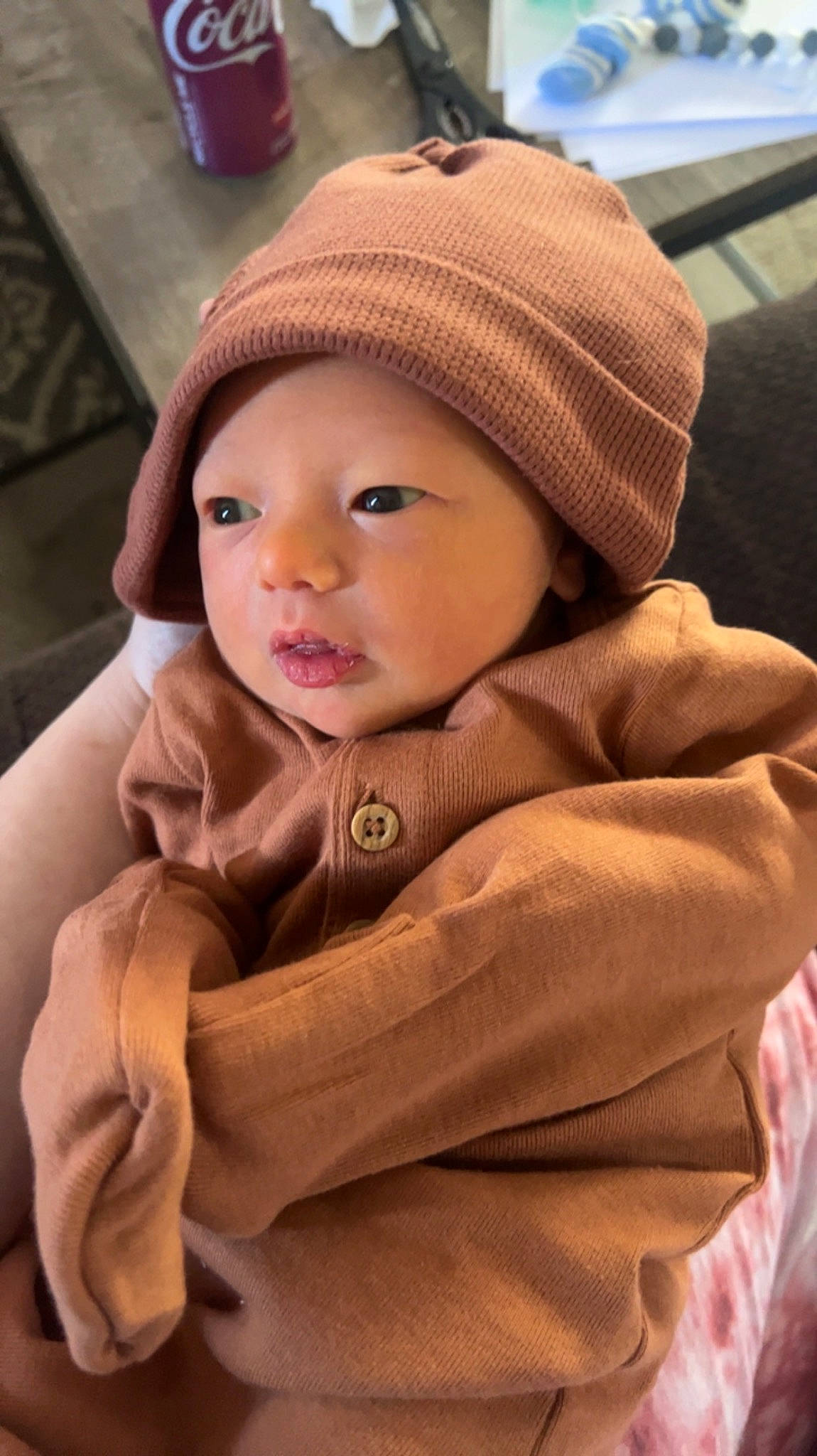 Denver is registered to the contest to win money with this photo: baby, baby_toddler_clothing, cap, cheek, child, comfort, face, fashion_accessory, fun, headgear, headwear, jacket, knit_cap, lip, outerwear, person, sitting, skin, sleeve, smile