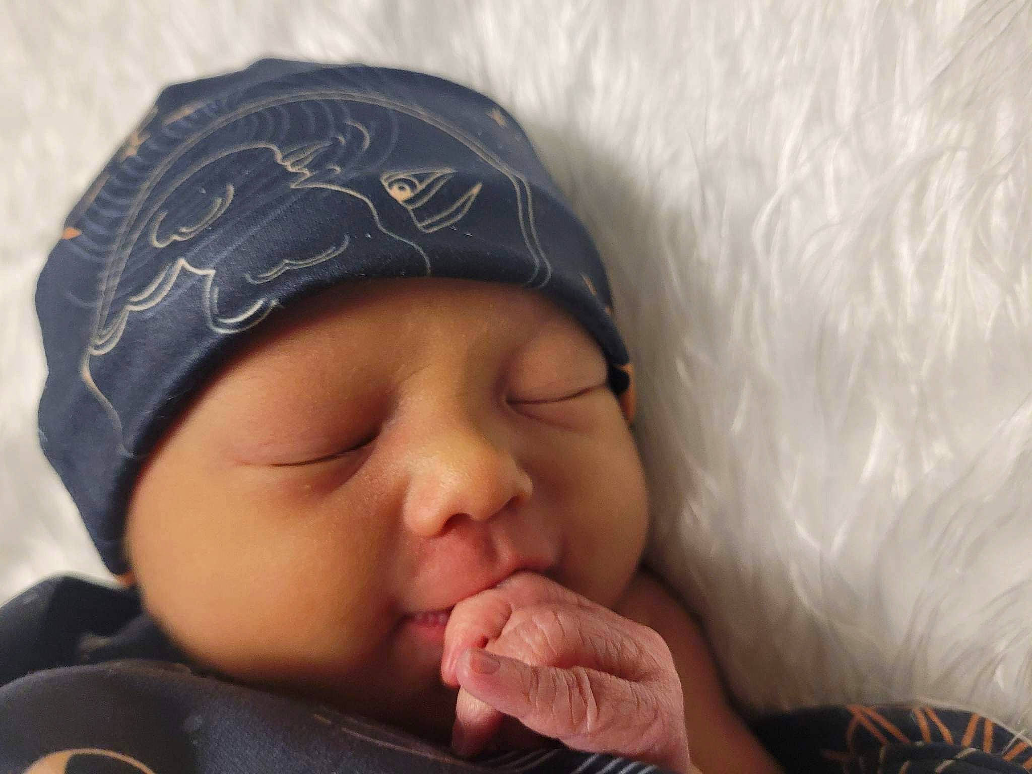 Denver joined the competition — help win amazing prizes! baby, baby_sleeping, cap, cheek, child, comfort, eyebrow, eyelash, finger, gesture, happy, headgear, headwear, knit_cap, lip, mouth, nose, person, skin, smile