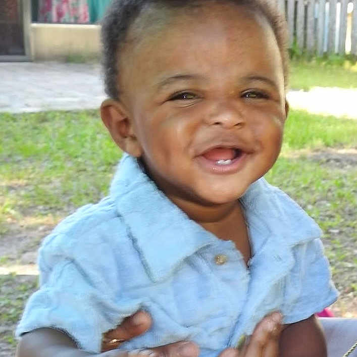 Khaza joined the competition — help win amazing prizes! baby, background, casual_clothing, child, cute, daylight, fence, grass, hands, happy, joy, nature, outdoor, person, portrait, shirt, smiling, supporting_hands, toddler, young_child