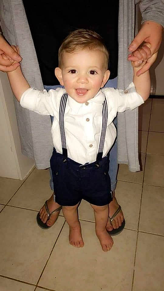 Jai is registered to the contest to win money with this photo: arm, child, finger, leg, person, smile, standing, thumb, toddler