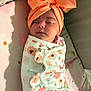 Isabella is registered to the contest to win money with this photo: baby, sleeping, headband, orange, blanket, floral, swaddle, infant, cute, peaceful, soft_light, indoors, closeup, portrait, newborn, face, wrapped, child, resting, adorable