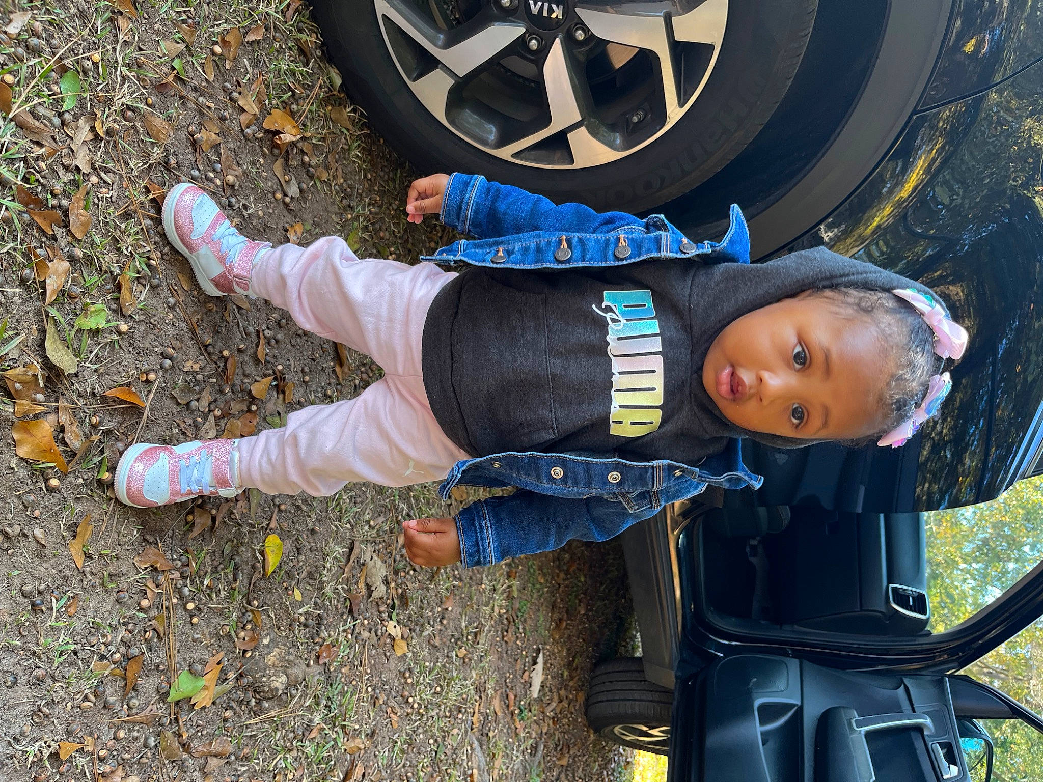 Za'Nylah is registered to the contest to win money with this photo: auto_part, automotive_design, automotive_exterior, automotive_lighting, automotive_tire, automotive_wheel_system, electric_blue, fun, grass, hubcap, jacket, light, motor_vehicle, people_in_nature, person, personal_protective_equipment, rim, surprise, tire, tire_care