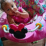 River joined the competition — help win amazing prizes! baby, child, pink, baby_walker, toy, snack, curly_hair, floor, indoor, colorful, floral_pattern, seat, playful, infant, cute, person, young_child, clothing, hand, face