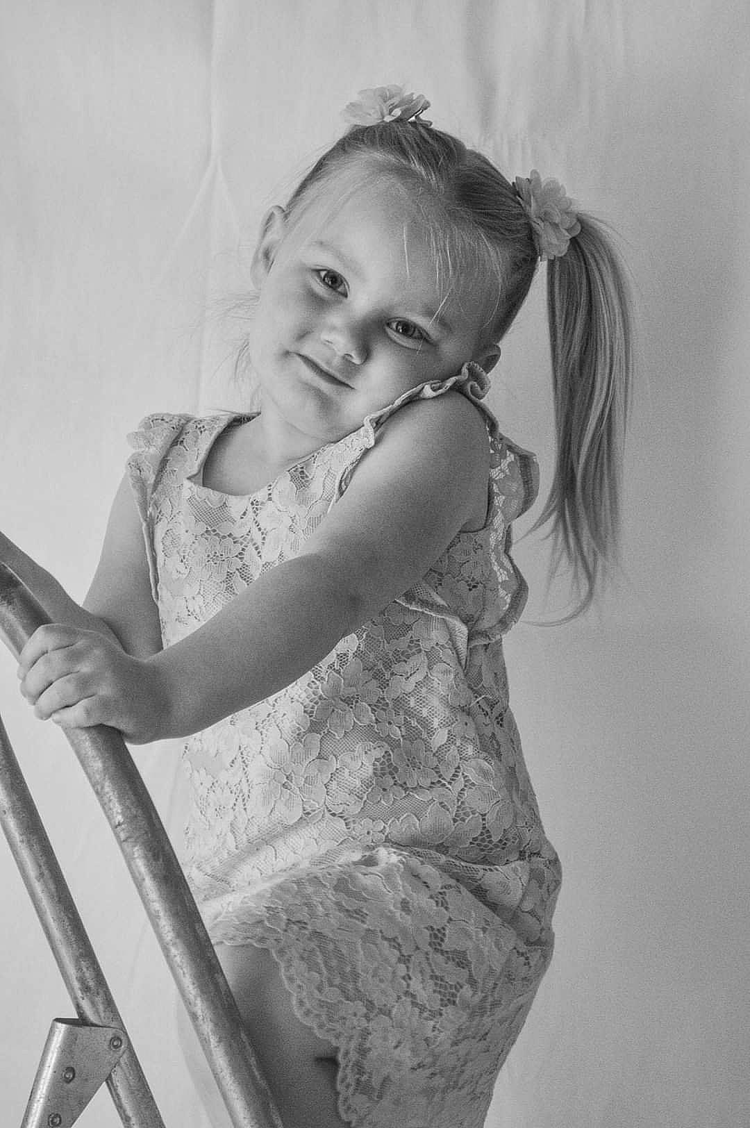 Jordyn is registered to the contest to win money with this photo: black_and_white, dress, elbow, eye, face, flash_photography, gesture, hair, hairstyle, happy, head, human_body, lip, long_hair, person, shoulder, skin, smile, style, waist