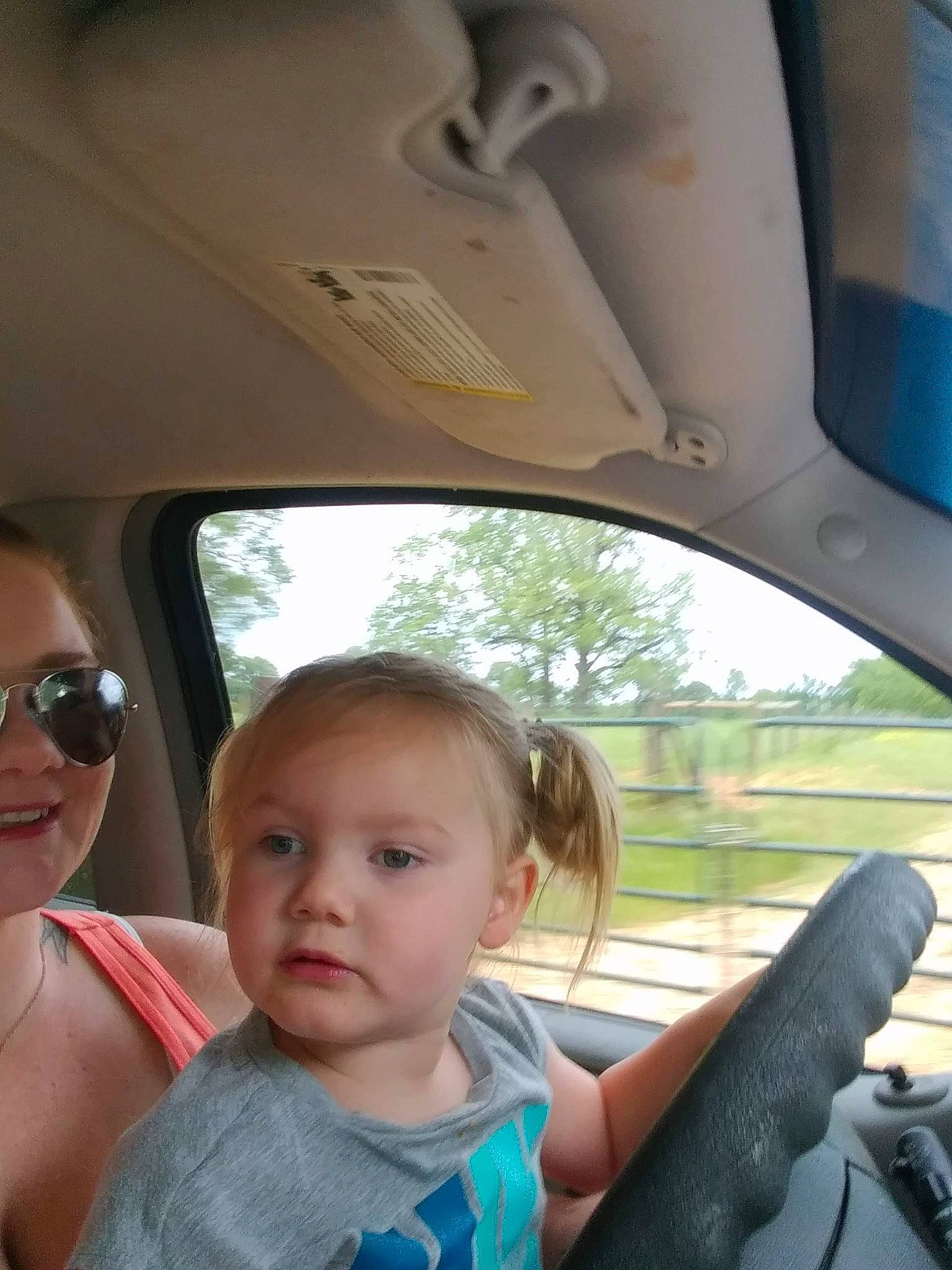 Jordyn joined the competition — help win amazing prizes! automotive_exterior, automotive_mirror, car, car_seat, face, goggles, mode_of_transport, motor_vehicle, person, plant, skin, smile, steering_part, steering_wheel, sunglasses, toddler, travel, vehicle, vehicle_door, white