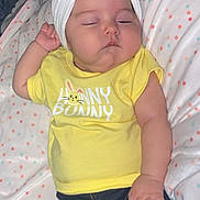 Raelynn is registered to the contest to win money with this photo: baby, sleeping, headband, bow, yellow_shirt, polka_dot_blanket, infant, cute, peaceful, child, clothing, resting, lying_down, soft, cozy, portrait, indoor, adorable, newborn, toddler