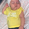 baby, sleeping, headband, bow, yellow_shirt, polka_dot_blanket, infant, cute, peaceful, child, clothing, resting, lying_down, soft, cozy, portrait, indoor, adorable, newborn, toddler