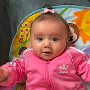 Ilyana a rejoint le concours — aidez-le/la à gagner de superbes lots ! baby, child, pink_clothing, tracksuit, adorable, face, big_eyes, playmat, indoor, cute, infant, smiling, colorful, toy, young_child, head, hair_bow, sitting, person, portrait