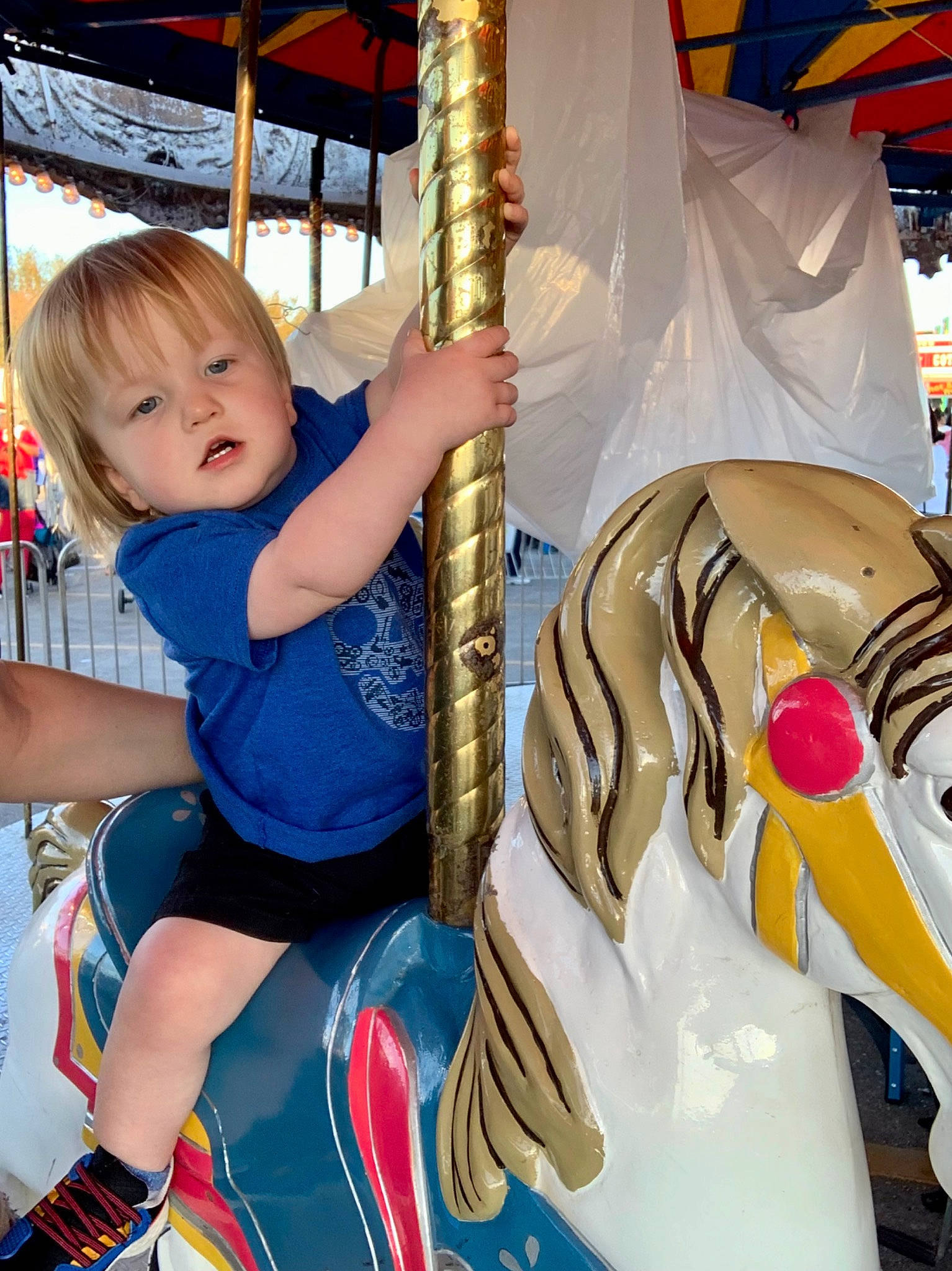 John joined the competition — help win amazing prizes! amusement_park, amusement_ride, baby_toddler_clothing, carousel, child, city, electric_blue, event, fun, lap, leisure, nonbuilding_structure, person, photograph, playground, public_space, recreation, sitting, snapshot, thigh