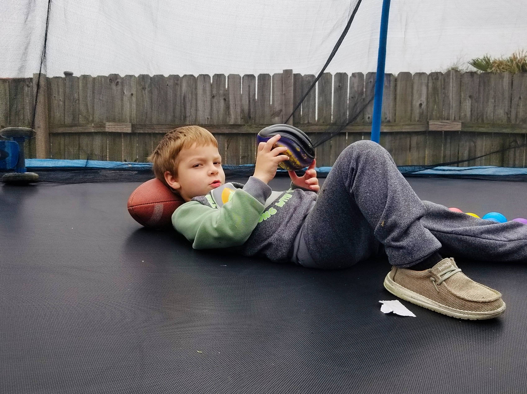 Baron joined the competition — help win amazing prizes! asphalt, boot, denim, flooring, grass, hammock, human_leg, knee, leisure, person, personal_protective_equipment, player, recreation, road_surface, sidewalk, sitting, sport_venue, sports, sportswear, trampoline