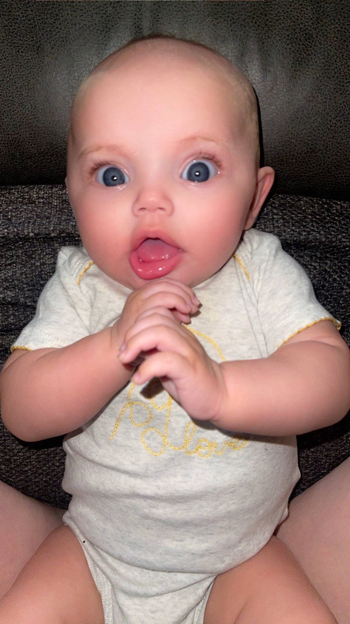 Adalynn is registered to the contest to win money with this photo: baby, baby_toddler_clothing, cheek, child, comfort, eye, eyelash, finger, gesture, human_leg, iris, lip, nail, nose, person, pink, sitting, skin, sleeve, surprise