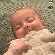 Ivie-Rose is registered to the contest to win money with this photo: baby, smile, blanket, sleeping, infant, cute, soft, cozy, happy, child, face, hand, resting, indoors, portrait, warm, comfort, peaceful, sleepy, toddler