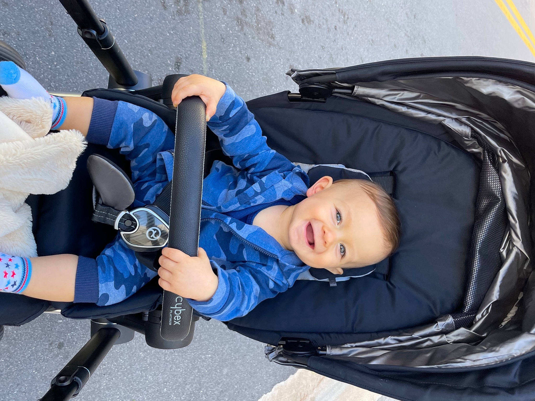 Ford is registered to the contest to win money with this photo: auto_part, automotive_design, automotive_exterior, automotive_tire, automotive_wheel_system, baby_carriage, baby_products, child, comfort, elbow, electric_blue, fun, gesture, human_body, joy, knee, leisure, person, product, sitting