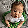 baby, bedspread, big_eyes, blanket, child, closeup, cute, feet, green_bows, green_skirt, hair, hands, indoors, infant, looking_up, playful, portrait, skin, smiling, white_shirt