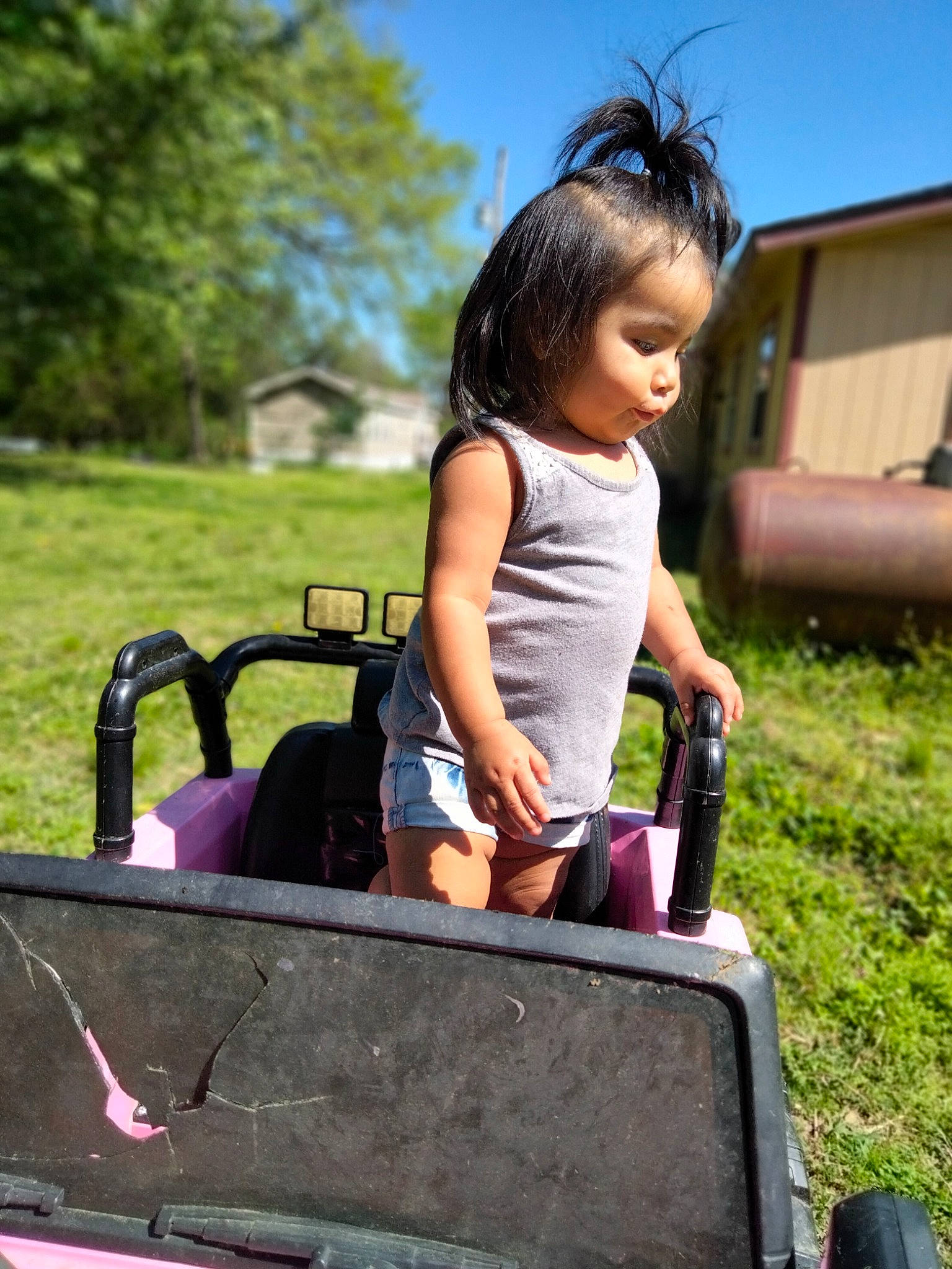 Malia is registered to the contest to win money with this photo: bag, child, city, fun, grass, happy, leisure, luggage_and_bags, magenta, motor_vehicle, outdoor_play_equipment, people_in_nature, person, plant, recreation, sitting, sky, street_fashion, toddler, travel