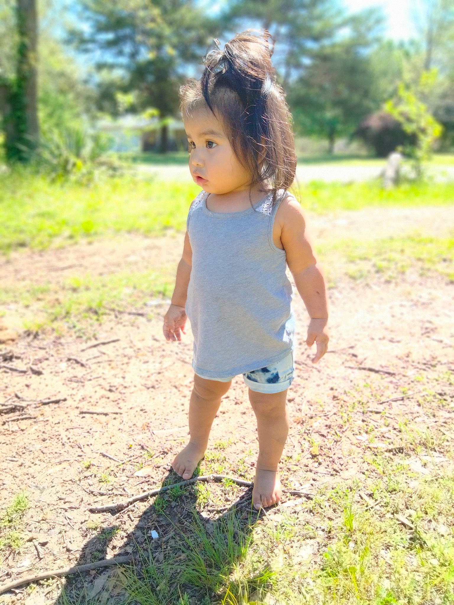 Malia joined the competition — help win amazing prizes! arm, electric_blue, footwear, forest, grass, grassland, happy, human_leg, leisure, meadow, people_in_nature, person, plant, recreation, sandal, shorts, sunlight, toddler, tree, waist