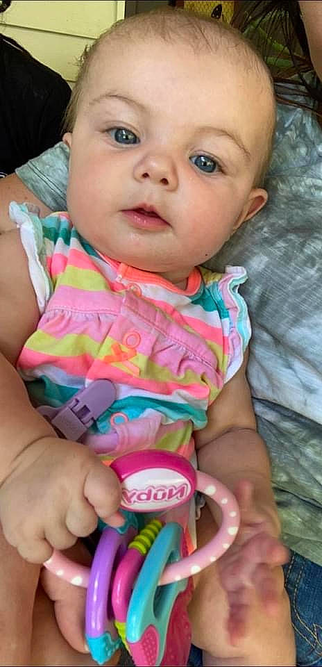 Irie is registered to the contest to win money with this photo: baby_toddler_clothing, cheek, eye, face, facial_expression, finger, hairstyle, hand, happy, human, iris, lip, mouth, nose, organ, person, photograph, product, skin, sleeve